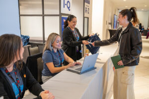 Group talking at reception desk for event